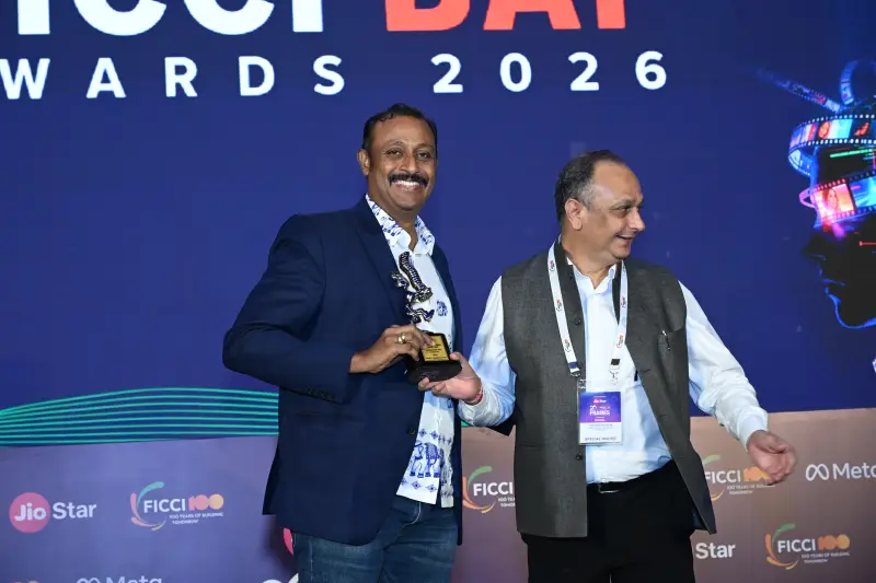 Two winners pose with a trophy on the FICCI BAF Awards 2026 stage.