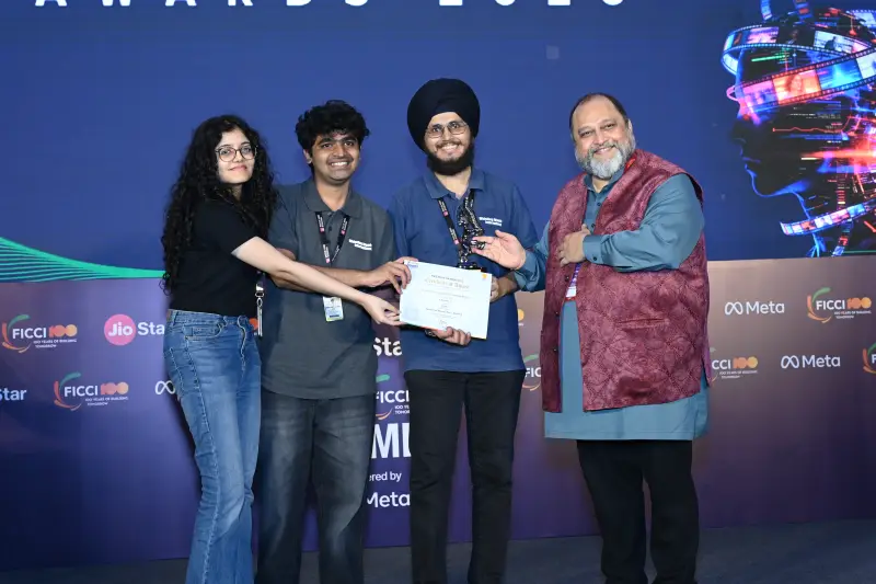 A group of young winners is handed a certificate by a presenter at the FICCI BAF Awards 2026.