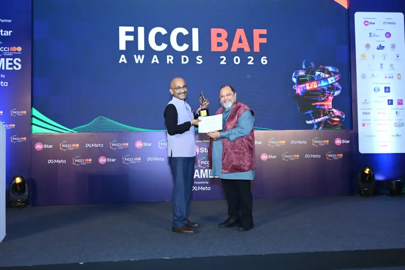 A winner receives his certificate on stage, framed by the FICCI BAF Awards 2026 screen.