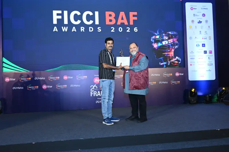 A winner collects his certificate on the FICCI BAF Awards 2026 stage.