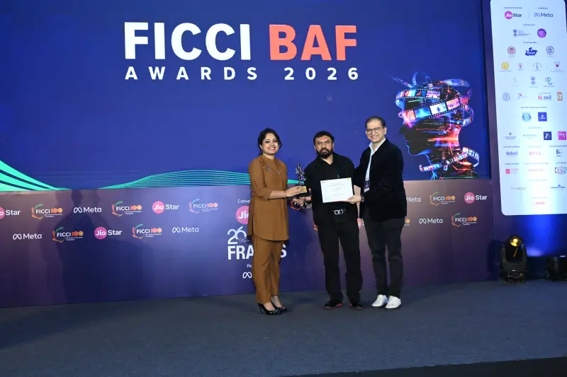 A winner flanked by two presenters at the FICCI BAF Awards 2026.