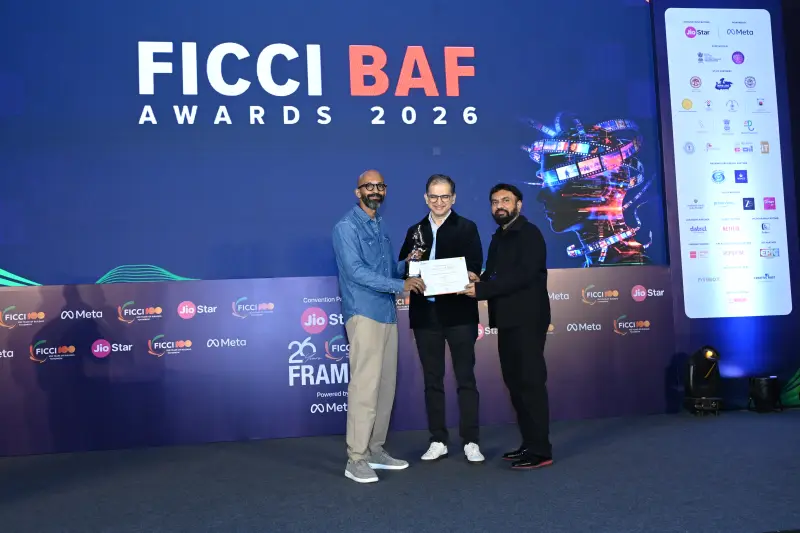 A trio on stage with the FICCI BAF Awards 2026 trophy.