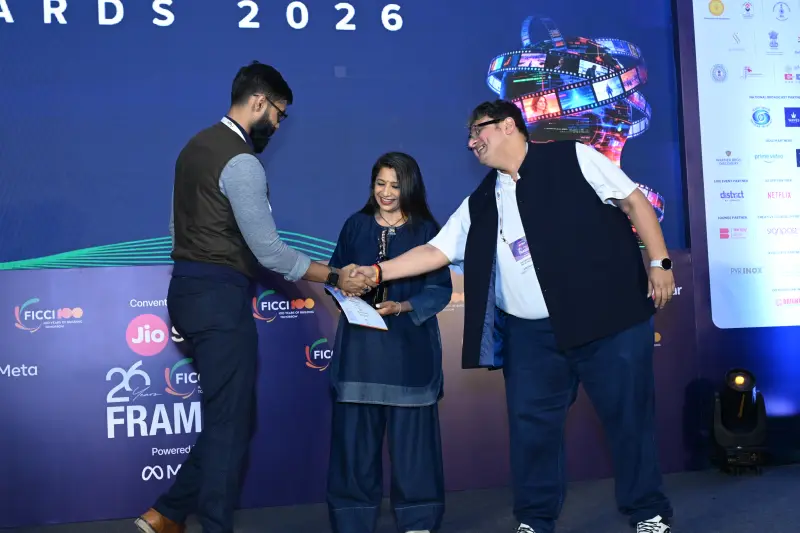 A winner shakes hands with a presenter as the award is given at the FICCI BAF Awards 2026.