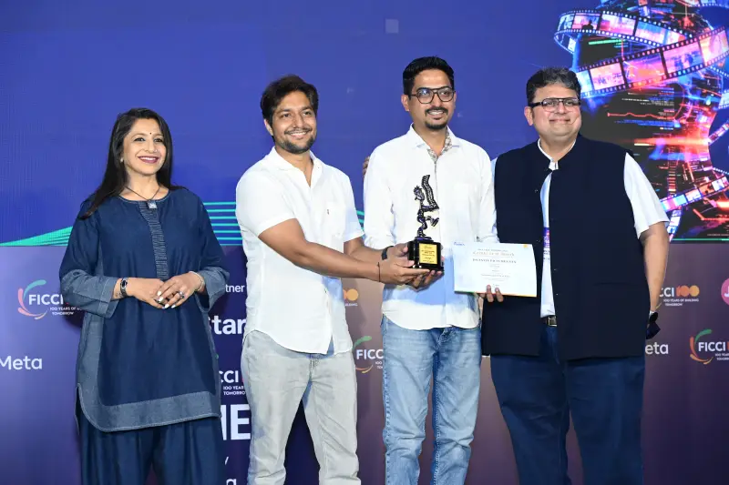 A winning pair receives their trophy and certificate from the presenters at the FICCI BAF Awards 2026.