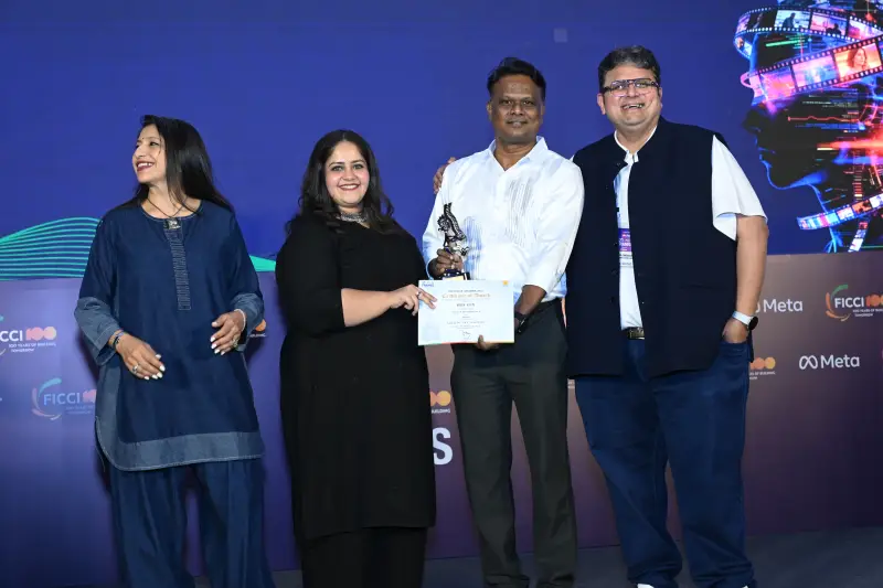 A winner receives his trophy and certificate from a group of presenters at the FICCI BAF Awards 2026.
