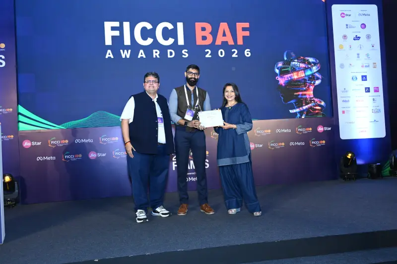 A winner receives his trophy and certificate at the FICCI BAF Awards 2026.