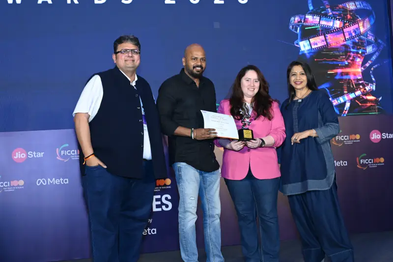 A winning team receives their certificate on stage at the FICCI BAF Awards 2026.