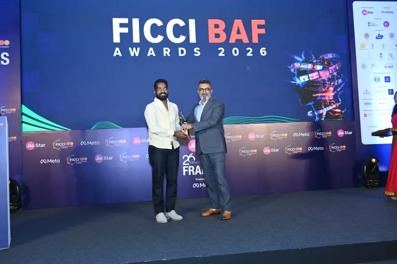 A winner collects his trophy on stage at the FICCI BAF Awards 2026.