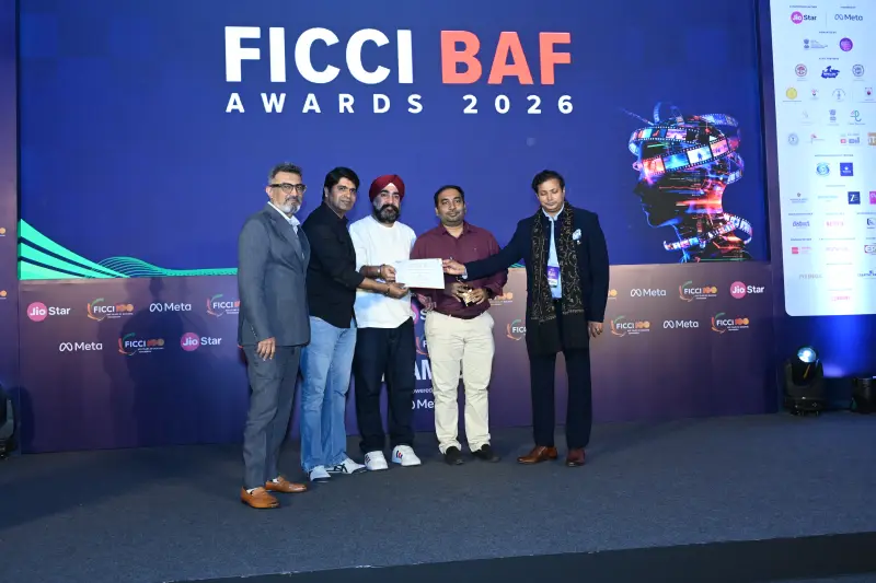 A winner receives his certificate among presenters at the FICCI BAF Awards 2026.