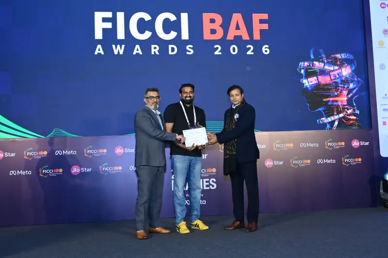 A winner receives his certificate from the presenters at the FICCI BAF Awards 2026.