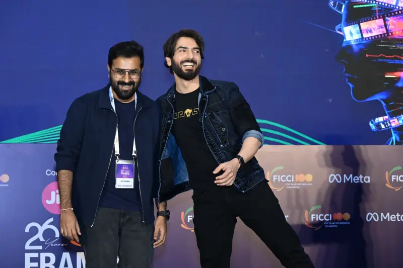 A winner poses with the host on the FICCI BAF Awards 2026 stage.