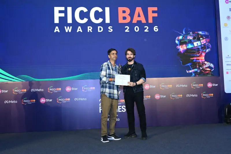 A winner collects his award from the host at the FICCI BAF Awards 2026.
