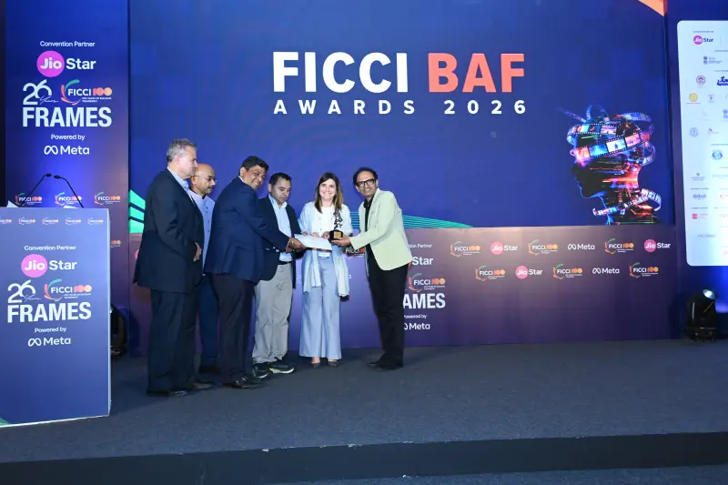 A winning team on stage with their award at the FICCI BAF Awards 2026.