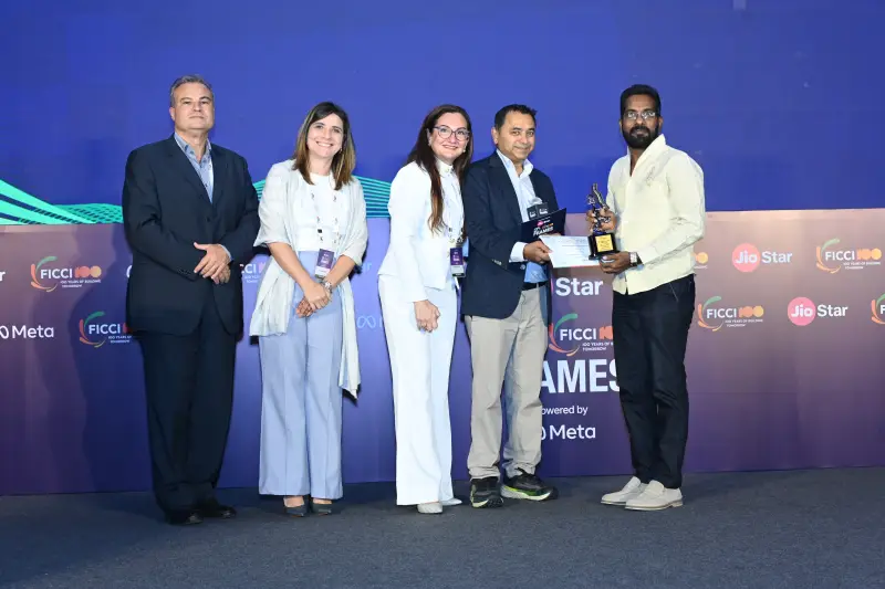 A winner receives a trophy among the presenters at the FICCI BAF Awards 2026.