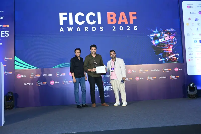 A winner collects his trophy on stage at the FICCI BAF Awards 2026.