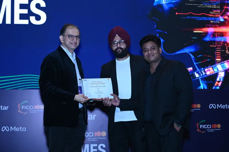 A winner receives his certificate from two presenters at the FICCI BAF Awards 2026.